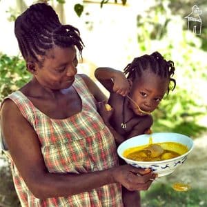 A mother feeding her child.